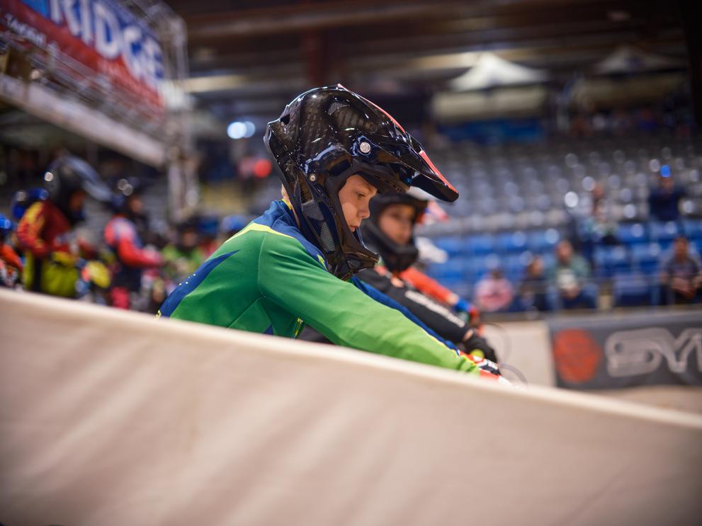 a young boy riding a bike in a stadium
